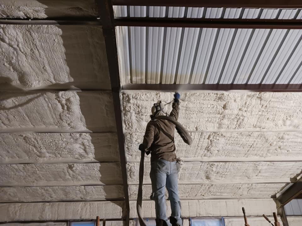 Installing 2lb polyurethene insulation in metal building ceiling in Spray Foam Insulation Louisiana